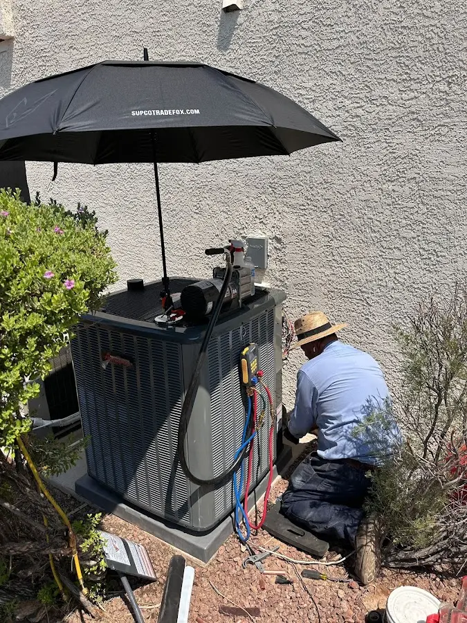 HVAC technician performing outdoor AC maintenance in Salem Lakes